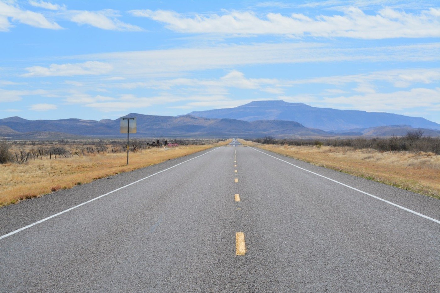 Empty West Texas highway toward the mountains